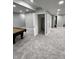 Finished basement with gray carpet and an open door to an unfinished area at 3389 Grant Ct, Columbus, IN 47203