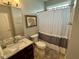 Well-lit bathroom with a vanity, mirror, toilet, shower-tub and patterned shower curtain at 3389 Grant Ct, Columbus, IN 47203