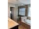 Bathroom view of the soaking tub, glass shower, and double sink vanity at 3389 Grant Ct, Columbus, IN 47203