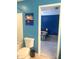 Cozy bathroom featuring a toilet, tub and shower combination, and colorful artwork hanging on the wall at 3389 Grant Ct, Columbus, IN 47203