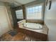 Bright bathroom features a soaking tub with tile surround and separate glass shower at 3389 Grant Ct, Columbus, IN 47203