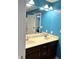 Bathroom features a double sink vanity with a large mirror reflecting a bedroom at 3389 Grant Ct, Columbus, IN 47203