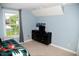 Comfortable carpeted bedroom features a window, dresser and small television at 3389 Grant Ct, Columbus, IN 47203