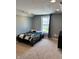 Carpeted bedroom featuring a bed, window overlooking front yard, and dresser at 3389 Grant Ct, Columbus, IN 47203