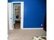 Blue bedroom features beige carpet and laundry room with washer/dryer combo through the doorway at 3389 Grant Ct, Columbus, IN 47203