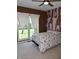 Light-filled bedroom with a bed, patterned accent wall, and window at 3389 Grant Ct, Columbus, IN 47203