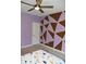 Cozy bedroom with patterned accent wall and ceiling fan at 3389 Grant Ct, Columbus, IN 47203