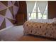 Bright bedroom with a bed, patterned accent wall, and window at 3389 Grant Ct, Columbus, IN 47203