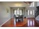 Spacious dining room with hardwood floors, a large window, and a staircase in the background at 3389 Grant Ct, Columbus, IN 47203