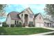 Charming two-story brick home with a stone entrance, well-kept lawn, and attached two-car garage at 3389 Grant Ct, Columbus, IN 47203