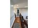 Hallway featuring wood floors, light gray walls, and a dark wood staircase at 3389 Grant Ct, Columbus, IN 47203