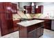 Modern kitchen with dark wood cabinets, granite countertops, stainless steel appliances, and tile backsplash at 3389 Grant Ct, Columbus, IN 47203