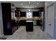 Well-lit kitchen with dark wood cabinets, stainless steel appliances, granite countertops, and tile floors at 3389 Grant Ct, Columbus, IN 47203