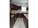 Well-equipped kitchen featuring stainless steel appliances, granite countertops, modern cabinets, and tile flooring at 3389 Grant Ct, Columbus, IN 47203