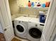 Laundry room featuring a washer and dryer, with an assortment of cleaning supplies on a shelf at 3389 Grant Ct, Columbus, IN 47203