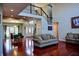 Spacious living room boasts hardwood floors, staircase, large windows, and comfortable sofas for relaxing and entertaining at 3389 Grant Ct, Columbus, IN 47203