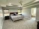 Spacious main bedroom with tray ceiling, plush carpeting, and access to the main bathroom at 3389 Grant Ct, Columbus, IN 47203
