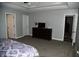 Main bedroom with dark wood furniture, flat screen tv and easy access to other rooms at 3389 Grant Ct, Columbus, IN 47203