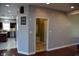Mudroom with a hall tree, white trim, dark red hardwood flooring, and a view of the kitchen at 3389 Grant Ct, Columbus, IN 47203