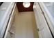 Pantry with a light, a dark red ceiling, an apron hanging on a hook, and a white door at 3389 Grant Ct, Columbus, IN 47203