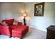 Relaxing sitting room features a red chair, patterned pillows, a decorative lamp, and gray walls at 3389 Grant Ct, Columbus, IN 47203