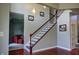 Open foyer with a wood staircase, railing, and carpeted living space beyond at 3389 Grant Ct, Columbus, IN 47203