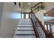 Elegant staircase features a wood railing, decorative metal spindles, and white risers at 3389 Grant Ct, Columbus, IN 47203