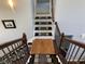 Wooden staircase with iron railing and carpeted steps, under overhead lighting at 3389 Grant Ct, Columbus, IN 47203