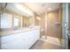 Bright bathroom with double sink vanity and modern tiled shower with glass doors at 4622 Crosby Buck Dr, Indianapolis, IN 46237