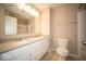 Bathroom with double sinks, a large mirror, and a toilet with a shower and bath combination at 4622 Crosby Buck Dr, Indianapolis, IN 46237
