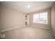 Bedroom with neutral walls, carpet flooring, and a window offering natural light at 4622 Crosby Buck Dr, Indianapolis, IN 46237