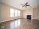 Comfortable living room with a fireplace, ceiling fan, and beautiful wood floors at 4622 Crosby Buck Dr, Indianapolis, IN 46237