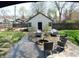 Backyard featuring a patio area with an outdoor seating area, a firepit, and a shed with outdoor green space at 4815 Carrollton Ave, Indianapolis, IN 46205