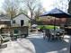 Backyard deck area featuring an outdoor table, chairs, firepit, and string lights creating an outdoor oasis at 4815 Carrollton Ave, Indianapolis, IN 46205
