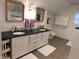 Bright bathroom with double vanity, granite countertop, and white tiled walls at 4815 Carrollton Ave, Indianapolis, IN 46205