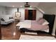 Stylish bedroom with sitting area, hardwood floors, and sliding door access at 4815 Carrollton Ave, Indianapolis, IN 46205
