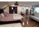 Serene bedroom features a sitting area, wooden floors, and sliding doors to an ensuite at 4815 Carrollton Ave, Indianapolis, IN 46205