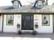 Close-up on front door showcasing a welcoming entrance, attractive curb appeal and sidelight windows at 4815 Carrollton Ave, Indianapolis, IN 46205