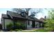 Quaint home with dormer windows and a lovely facade, complemented by lush greenery and mature trees at 4815 Carrollton Ave, Indianapolis, IN 46205