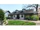 Charming home featuring a well-manicured lawn and inviting facade with dormer windows and a covered porch at 4815 Carrollton Ave, Indianapolis, IN 46205