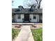 Home's front facade, showcasing a welcoming entrance, manicured landscaping, and attractive curb appeal at 4815 Carrollton Ave, Indianapolis, IN 46205