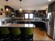 Well-equipped kitchen featuring stainless steel appliances, bar seating, and modern lighting at 4815 Carrollton Ave, Indianapolis, IN 46205
