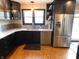Modern kitchen featuring stainless steel appliances, ample countertop space, and black cabinetry at 4815 Carrollton Ave, Indianapolis, IN 46205
