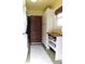 Functional laundry area showcases storage cabinets, a wooden shelf, and a dark sliding door at 4815 Carrollton Ave, Indianapolis, IN 46205