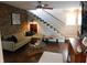 Open living area features brick wall, modern furniture, staircase, and decorative finishes at 4815 Carrollton Ave, Indianapolis, IN 46205