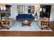 Stylish living room featuring a blue couch, modern decor, and hardwood floors at 4815 Carrollton Ave, Indianapolis, IN 46205