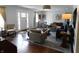 Bright and airy living room with hardwood floors, a mix of seating, and natural light streaming through the front door at 4815 Carrollton Ave, Indianapolis, IN 46205