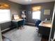 Home office with two desks, modern decor, two chairs, and neutral walls at 4815 Carrollton Ave, Indianapolis, IN 46205