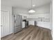 The spacious kitchen boasts stainless steel appliances, white cabinets, and durable vinyl flooring at 491 Westview Dr, Bargersville, IN 46106