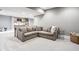 Spacious basement area featuring a comfortable sectional sofa and a kitchenette in the background at 496 Bridgemont Ln, Carmel, IN 46032